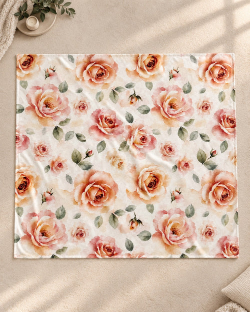 The blanket laid flat and photographed from above, showing the full watercolor rose print edge to edge