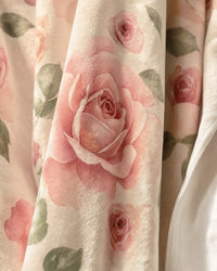Close detail of the plush velveteen pile showing the watercolor roses printed into the nap and the stitched edge