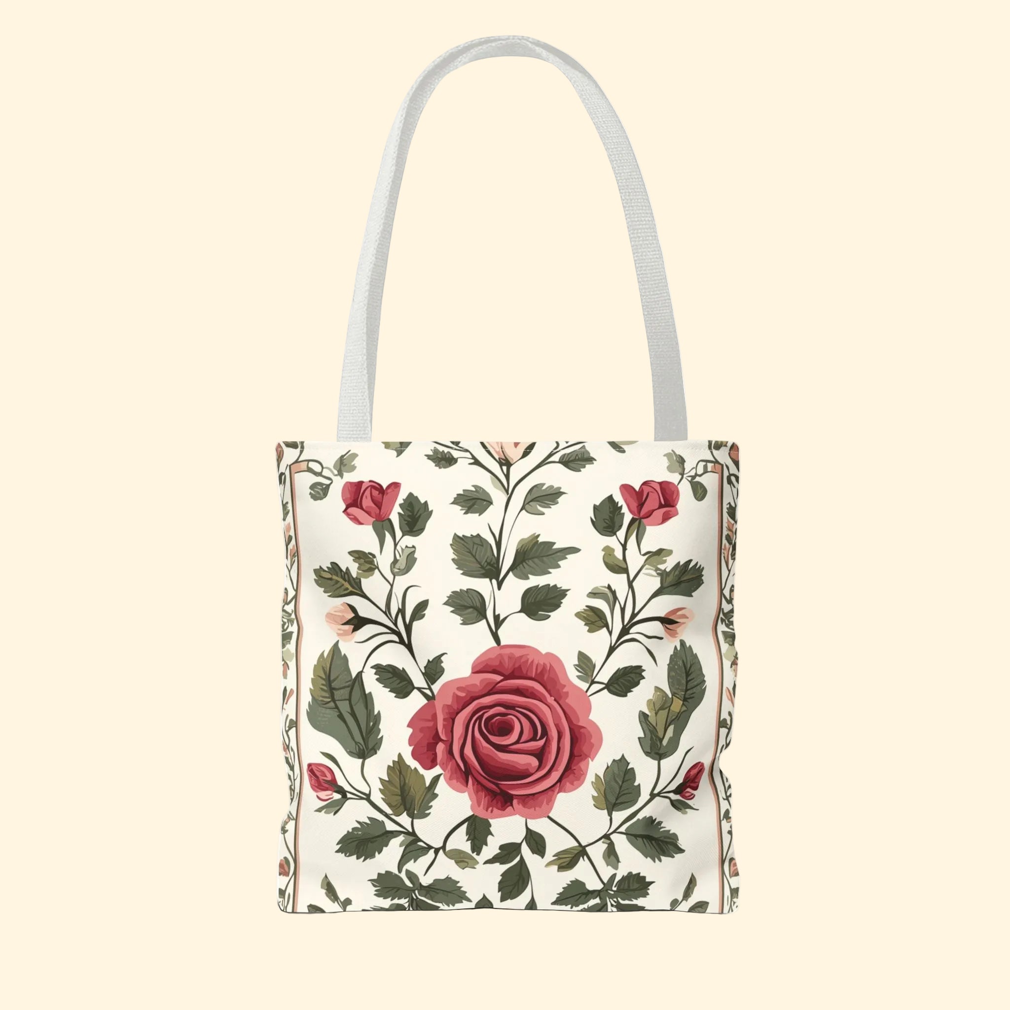 Floral tote bag with red roses and green leaves on a white background