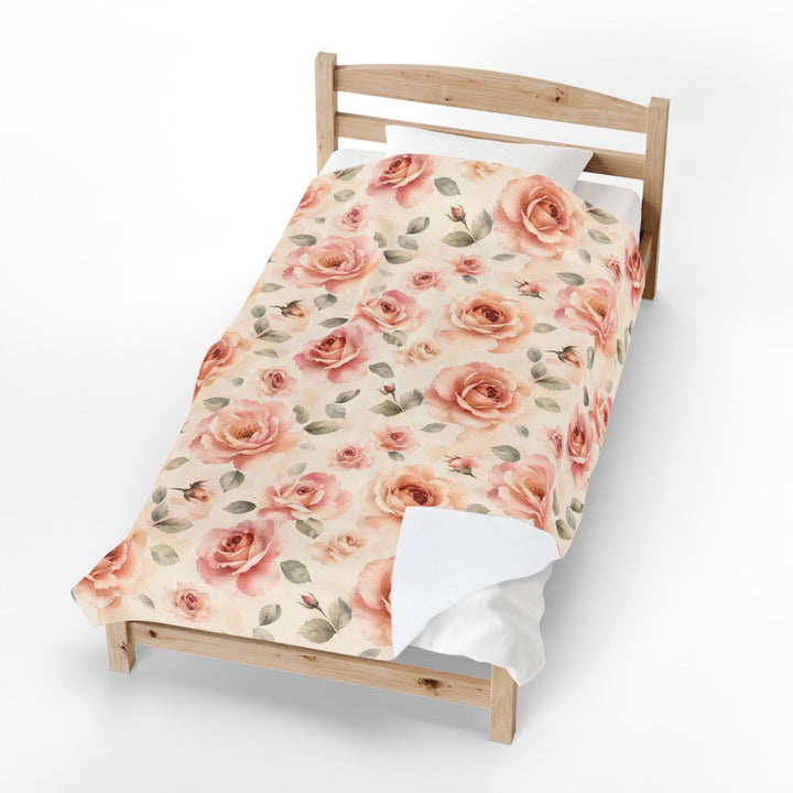 The blanket folded over a wooden bed frame, showing its full length