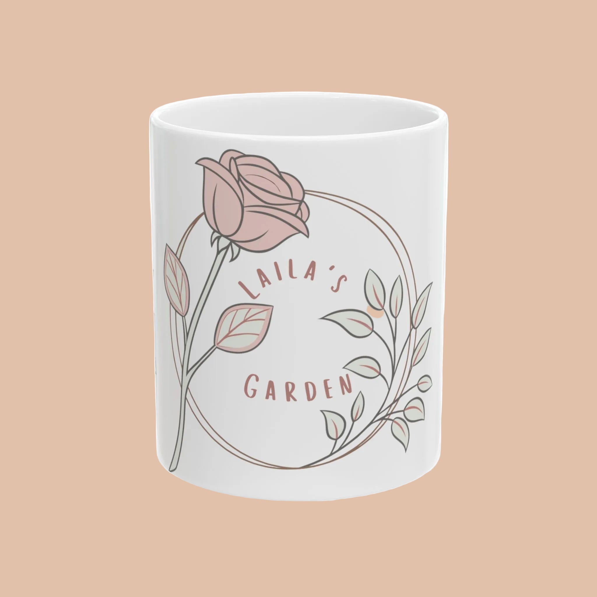 White mug with a pink rose design and 'Laila's Garden' text on a white background