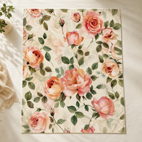 Bloom with Hope blanket draped on chair — soft rose pattern from Laila's Garden